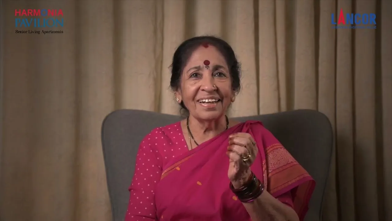 A Harmonia Pavilion resident, seated in her apartment, talking about living there